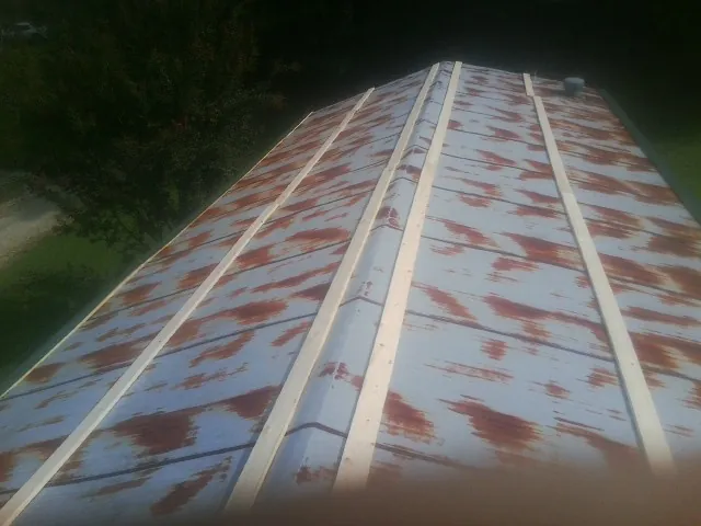 Rusted metal roof panels with new wood purlins before replacement — Storm Damage Roof Repair in Panama City Beach by Roofing Brothers